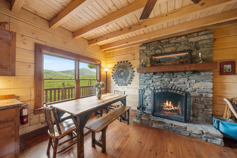 Stacked Stone Wood Burning Fireplace Graces the Living Room, Kitchen and Dining Area