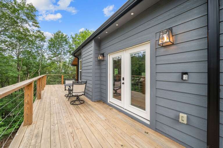 Wrap Around Deck Opens on the Side with Additional Seating in the Wooded Setting Wrap Around Deck Opens on the Side with Additional Seating in the Wooded Setting