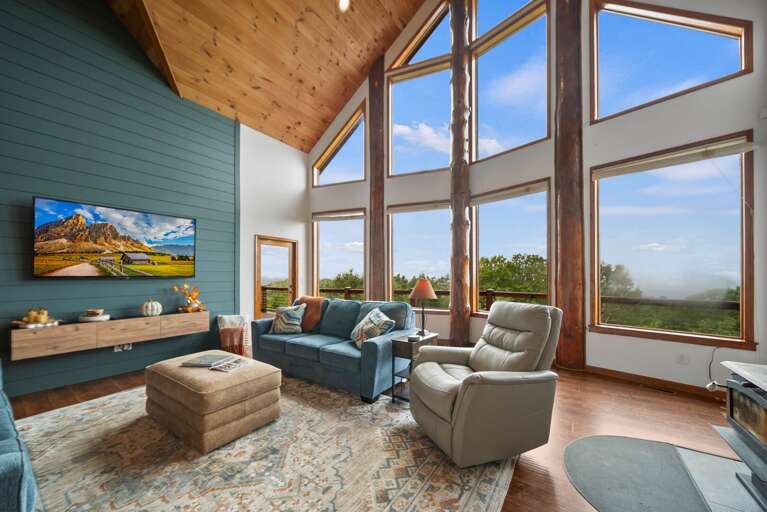 Comfortable Living Room with TV and A Wall of Windows