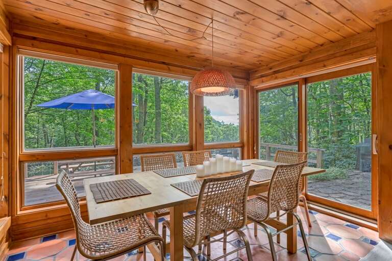 Dining Room Flaked by Windows, Leads to the Patio