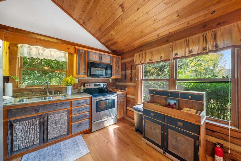 Quaint Kitchen with Granite Counters and Stainless Appliances