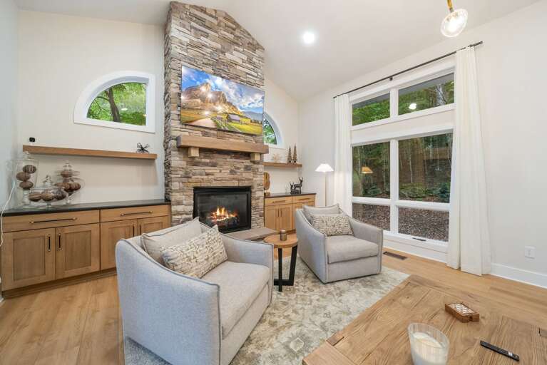 Stacked-Stone Gas Fireplace and TV in the Cozy Main Floor Living Room Stacked-Stone Gas Fireplace and TV in the Cozy Main Floor Living Room