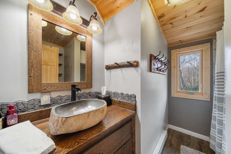 Master Bathroom with Floating Stone Sink and Tub and Shower Combo