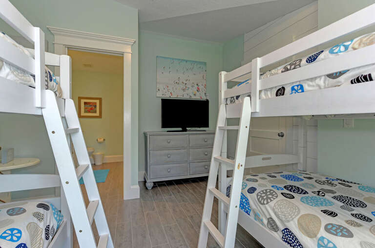 separated from main living area with 1/2 bath. Den area with 1 twin bunk beds and the second bunk is now a single twin bed