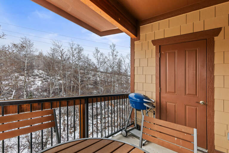 Step onto your private covered balcony and breathe in crisp alpine air while admiring snow-dusted trees and peaceful winter mountain scenery. Perfect for morning coffee or grilling outdoors year-round.