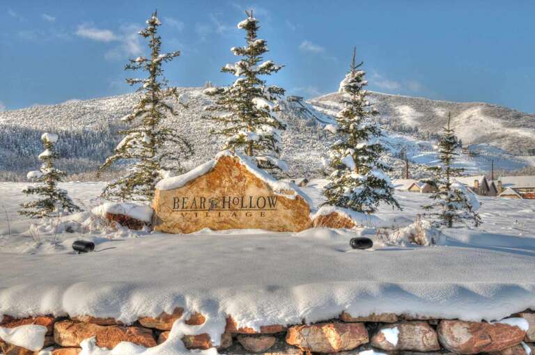Bear Hollow Village welcomes guests to this pristine mountain community, framed by snow-dusted pines and stunning alpine terrain for an unforgettable winter escape.