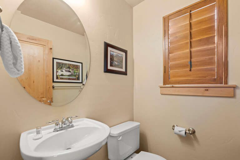Freshen up in your private bathroom, warmly lit and finished with wood accents and thoughtful touches for your comfort.