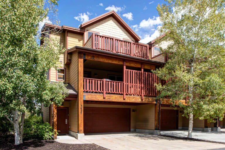 This charming mountain retreat features rustic wood details and spacious balconies framed by aspens, with convenient ground-level parking enhancing your arrival experience.