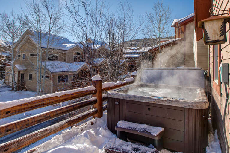 Soak in the steaming hot tub on your private balcony, surrounded by snowy mountain views and crisp winter air—pure alpine relaxation awaits.