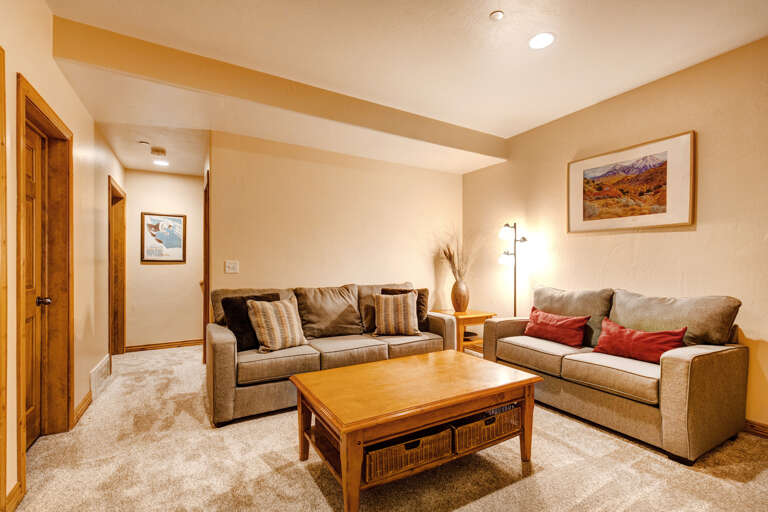 Unwind in your inviting living room, where plush sofas and warm lighting create the perfect space for relaxation after a day of adventure.