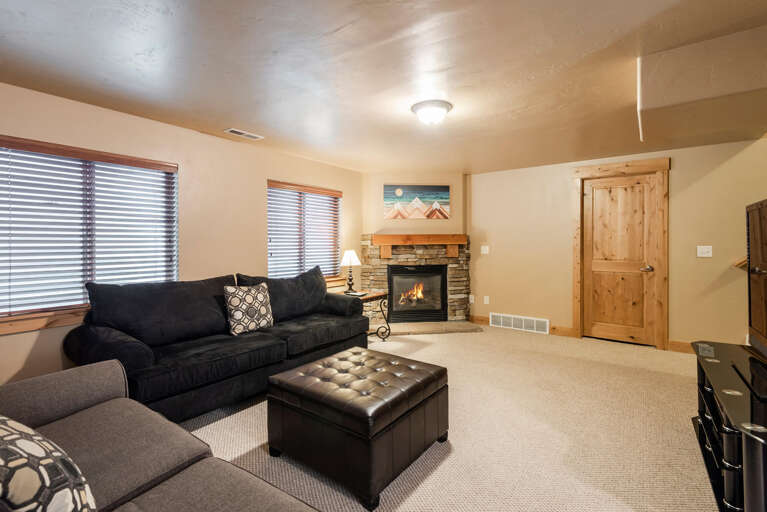 Bear Hollow 5557: Cozy sofa set by the warm fireplace, perfect for relaxation. Bear Hollow 5557: Cozy sofa set by the warm fireplace, perfect for relaxation.