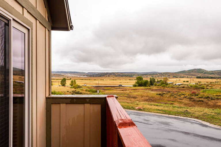 Property offering expansive countryside vistas across golden fields and distant rolling hills, situated in a peaceful rural setting with open skies and natural surroundings.