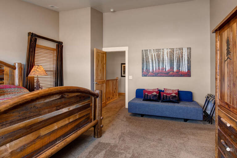 Unwind in your cozy retreat, where rustic charm meets modern comfort. Sink into the plush sofa, admire the serene forest artwork, and relax surrounded by warm wood tones and thoughtful touches.