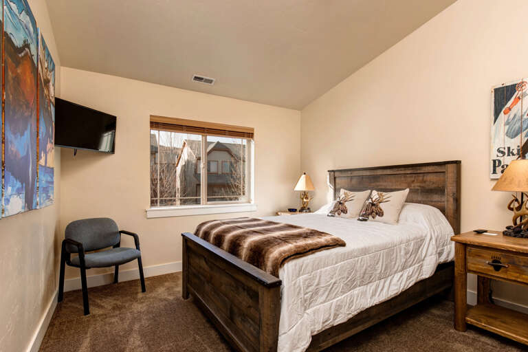 Sink into a plush bed with a cozy faux-fur throw, warm lighting on rustic nightstands, and mountain-inspired décor that brings the outdoors in for your perfect alpine retreat.