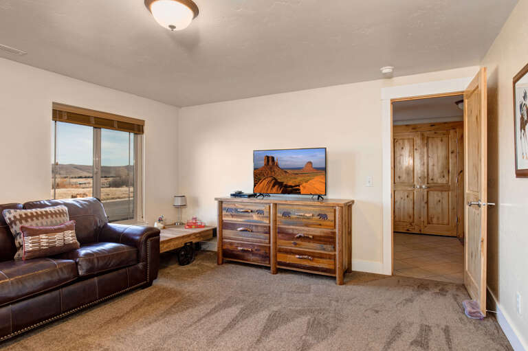 Kick back in your cozy living room, where rustic charm meets comfort. Sink into the leather sofa, catch your favorite shows, and enjoy stunning views through the window.