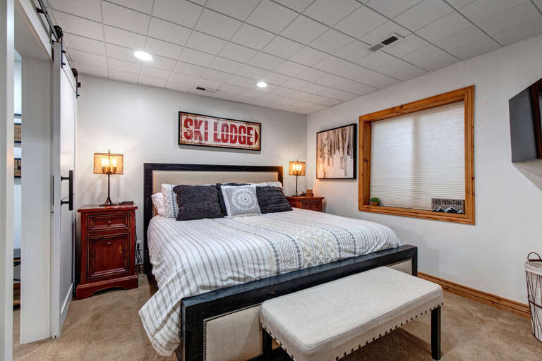 Sink into the plush king bed after a day of adventure. Warm lighting and ski lodge touches create a cozy mountain retreat where your best sleep awaits.