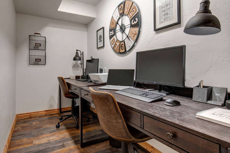 Your dedicated workspace features a spacious wooden desk, dual monitors, and vintage-inspired décor to keep you productive and inspired throughout your stay.