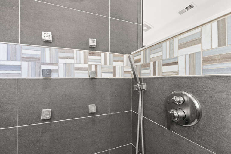 Refresh in a beautifully tiled walk-in shower with modern fixtures and soothing body jets for your ultimate comfort.