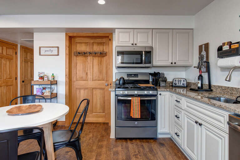 Step into a fully equipped kitchen ready for your culinary adventures, featuring granite countertops, modern appliances, and a cozy dining nook where morning coffee tastes even better.