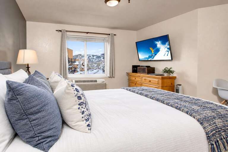 Wake up to stunning snow-capped mountain views framed by your bedroom window. Crisp white linens, cozy textures, and thoughtful touches create your perfect alpine retreat.
