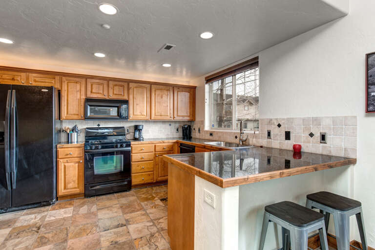 Foxpoint 6195-C2 - Kitchen: "Sleek countertops, modern appliances, and cozy bar stools create a welcoming space."