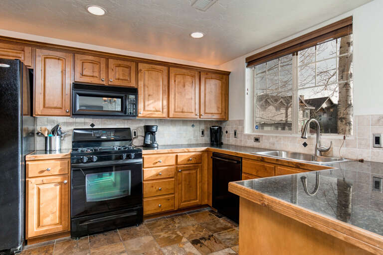 Foxpoint 6195-C2 - Modern appliances and ample storage in sleek kitchen design.