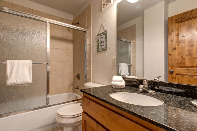 Foxpoint 6195-C2 - Sleek sink, mirror, toilet, and convenient tub shower combo.