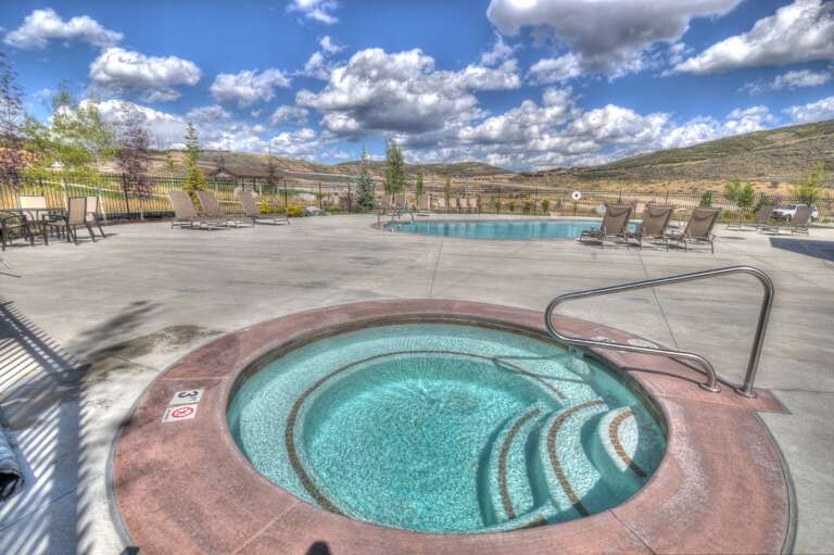 Soak your worries away in the inviting hot tub, then lounge poolside while taking in sweeping mountain views under a brilliant blue sky.