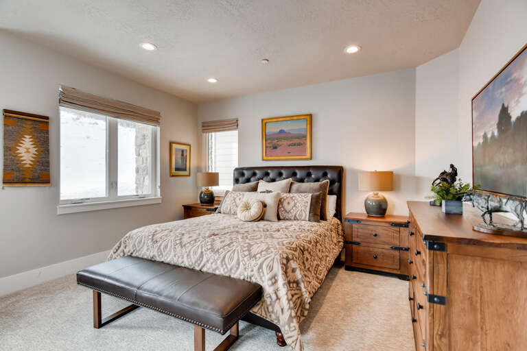 Jordanelle Estates 13299: Cozy bed by the window, inviting sofa for relaxation.