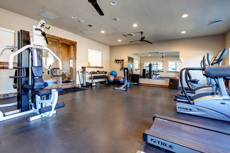Maintain your workout routine in a spacious, well-equipped fitness center featuring modern cardio machines, strength training equipment, and plenty of room to stretch and move.