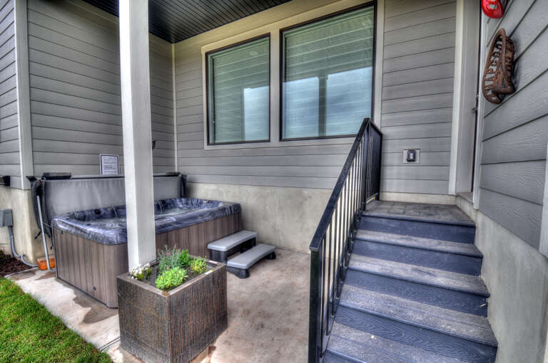 Your private entrance leads to a covered patio where a hot tub awaits, perfect for unwinding under the stars after a day of adventure.