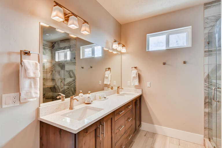 Jordanelle Estates 13299: Reflective sink area with a sleek mirror, perfect for morning routines.