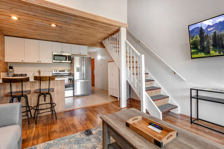 Cozy space with sofa bed, center table, and loft bedroom access.