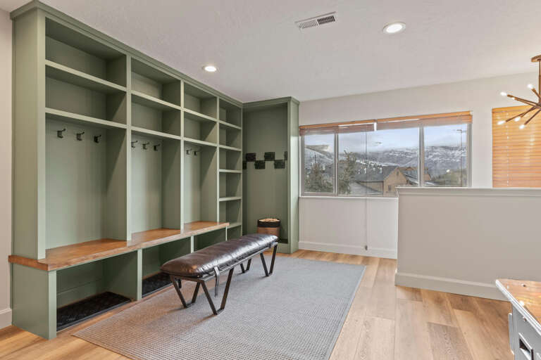 Living Room: "Functional entryway with bench, coat hooks, and ample storage space."