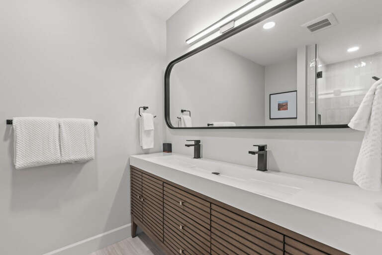 Prospector Lodge 536: Primary ensuite bathroom with dual sink vanity and lighted mirror.