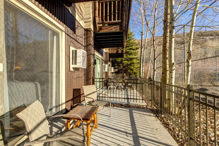 Serene setting with a cozy chair and table for relaxation. Serene setting with a cozy chair and table for relaxation.