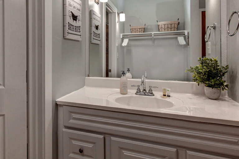 Reflective sink area with a sleek mirror, perfect for morning routines.