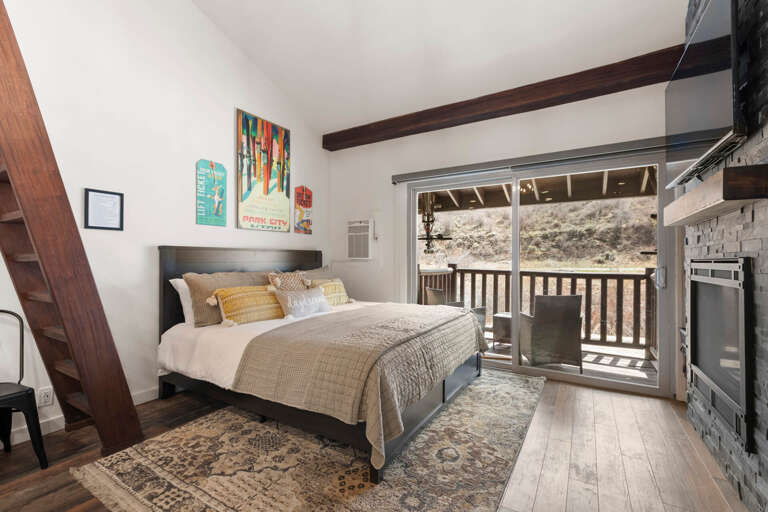 Main floor King bed. Easy access to balcony with seating and mountain views. Main floor King bed. Easy access to balcony with seating and mountain views.