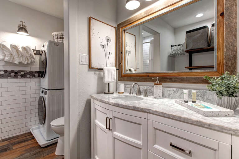 Reflective sink area with a sleek mirror, perfect for morning routines. Reflective sink area with a sleek mirror, perfect for morning routines.