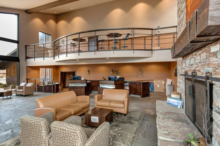 Step into a welcoming lobby with soaring ceilings, warm lighting, and contemporary mountain charm that sets the tone for your entire stay.
