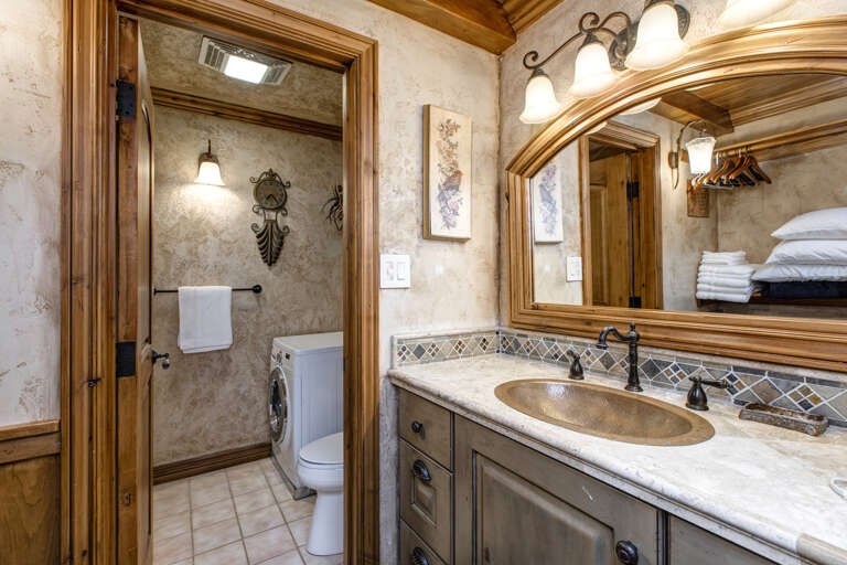 Reflective sink area with a sleek mirror, perfect for morning routines. Reflective sink area with a sleek mirror, perfect for morning routines.