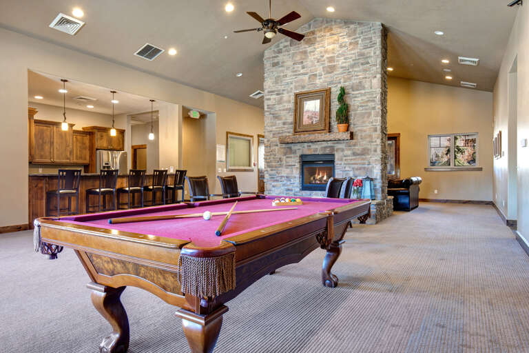 Challenge your friends to a game of pool in this welcoming lounge, where high ceilings and a glowing stone fireplace create the perfect backdrop for relaxation and friendly competition.