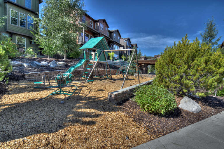 The property features an on-site playground nestled within a landscaped outdoor area, offering a safe and entertaining space for young guests to play and explore during their stay.