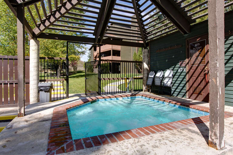 Unwind in your private hot tub beneath a sheltering pergola, where warm water soothes tired muscles while you soak in peaceful garden views and fresh mountain air.