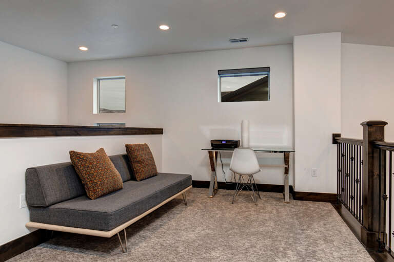 Unwind in your bright, modern living space featuring a chic seating area and dedicated workspace—perfect for catching up or simply relaxing in comfort.