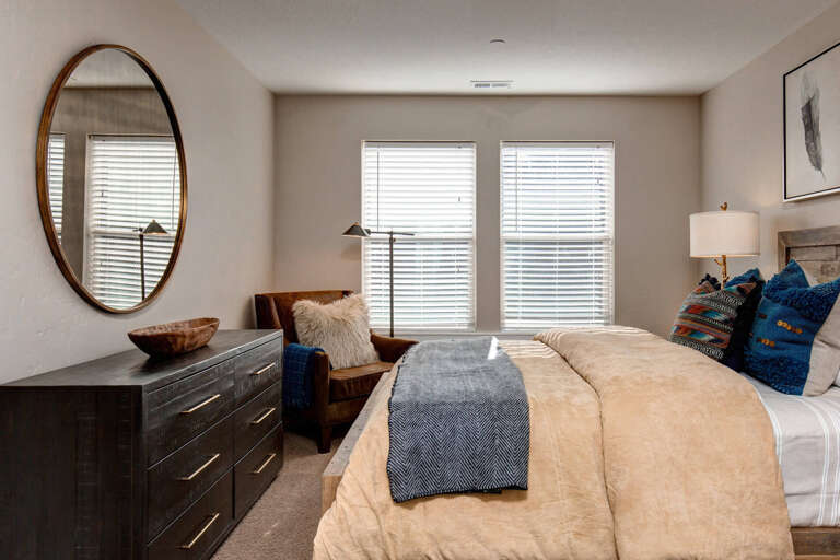 Settle into this cozy bedroom where natural light filters through and plush textures invite you to unwind after a day of adventure.