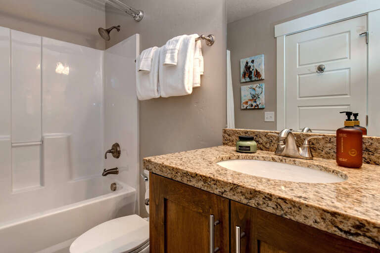Step into your private bathroom, where fluffy white towels await and polished granite counters gleam. The tub and shower combo invites you to unwind after a day of adventure.