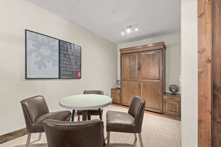 Gather around your private dining table for meals and conversation in this cozy, well-appointed space with warm wood accents.