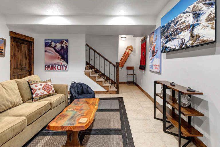 Settle into your cozy mountain retreat where vintage ski posters set the tone for adventure. Your comfortable seating area invites relaxation after a day on the slopes.
