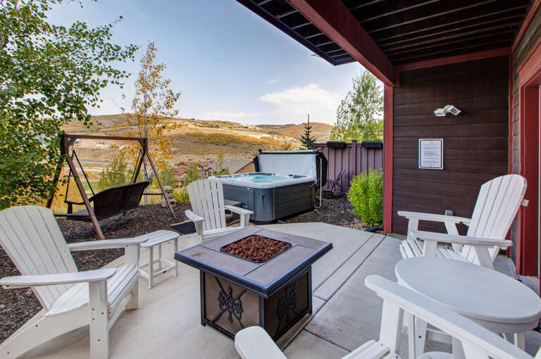 Unwind under the covered patio with a hot tub soak, cozy fire pit gatherings, and peaceful swings—all framed by sweeping mountain vistas.